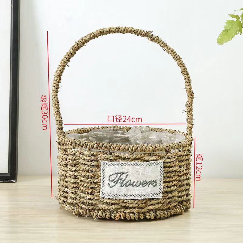Fabricantes de cestas de flores ovales rectas de paja hechas a mano en stock al por mayor cestas de flores de paja portátiles decoración de viento pastoral