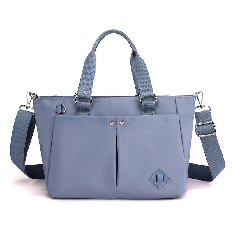 Nuevas tendencias de moda en 2025 bolsos de hombro de varias capas bolsos de hombro de gran capacidad para viajar y evitar salpicaduras de agua mochilas de versión coreana