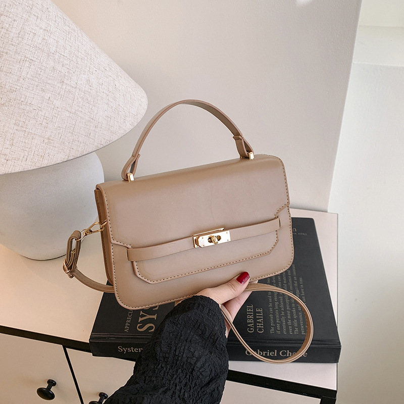 Bolso de mano de color sólido nuevo estilo 2025 simple bolso de hombro de primavera coreano de moda con cierre bolso pequeño