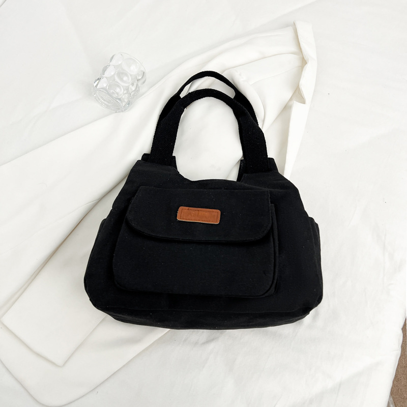 Bolsa de lona de gran capacidad para mujeres otoño-invierno 2024 nuevo estilo tideins viento brazalete bolsa de ocio estudiante bolsa de tote minimalista viento