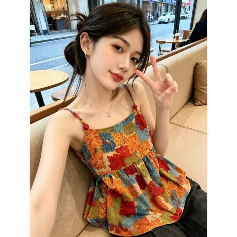 Real shot of a dopamine-infused floral print camisole tank top for women, featuring ruffled details and a sleeveless design perfect for vacation.