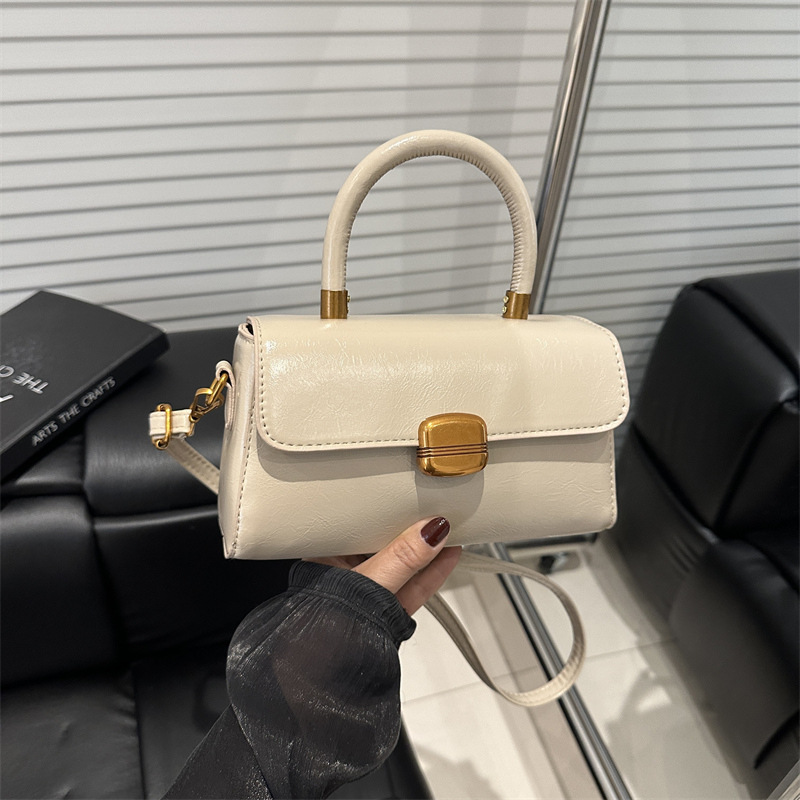 Nicho de diseño coreano bolso de mano 2025 primavera nuevo estilo simple de moda con cierre de flip de hombro monocolor bolso de mochila