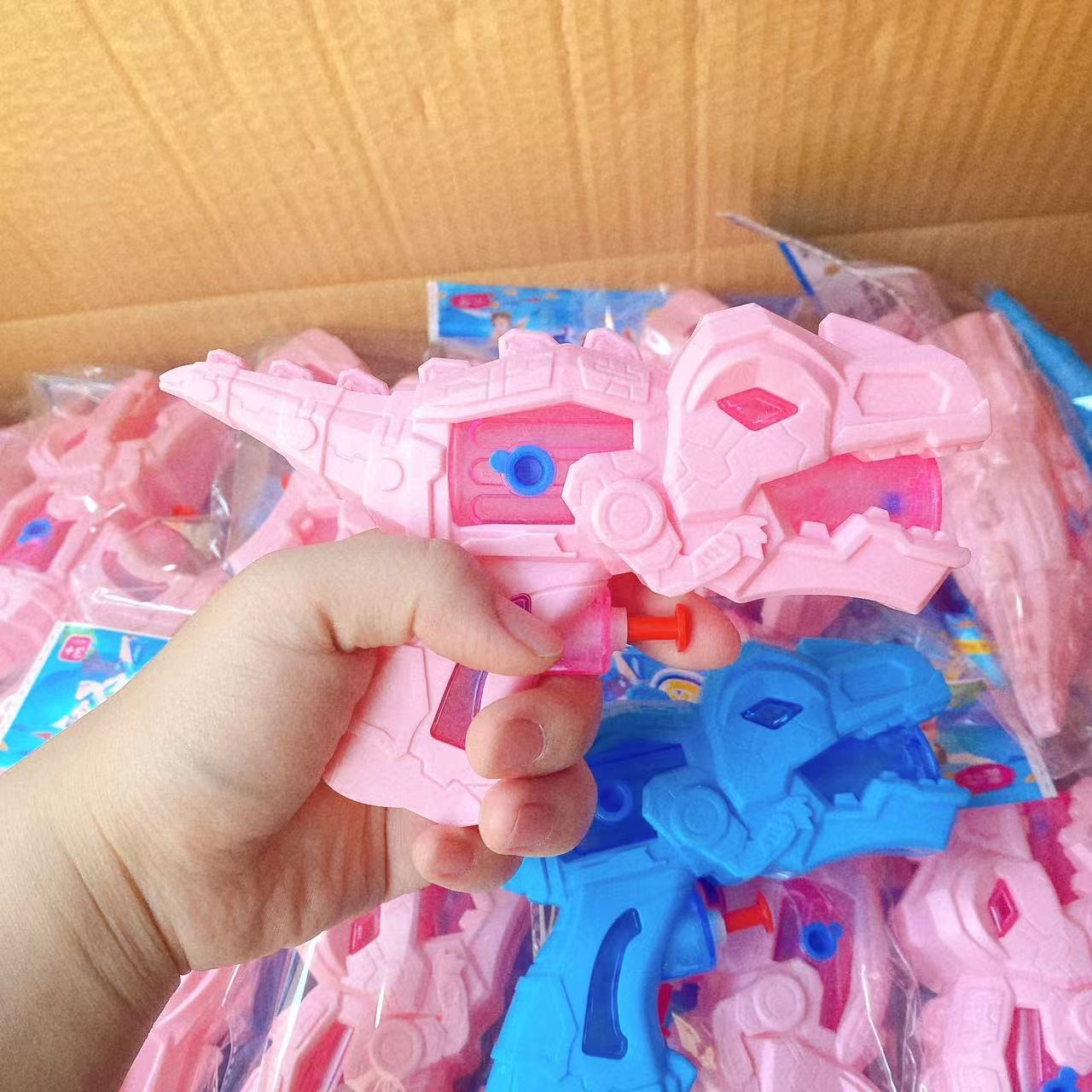 Juguetes infantiles pistolas de agua de dibujos animados dinosaurios pistolas de agua de tiburones pulverización de agua verano nuevo 2 yuanes al por mayor