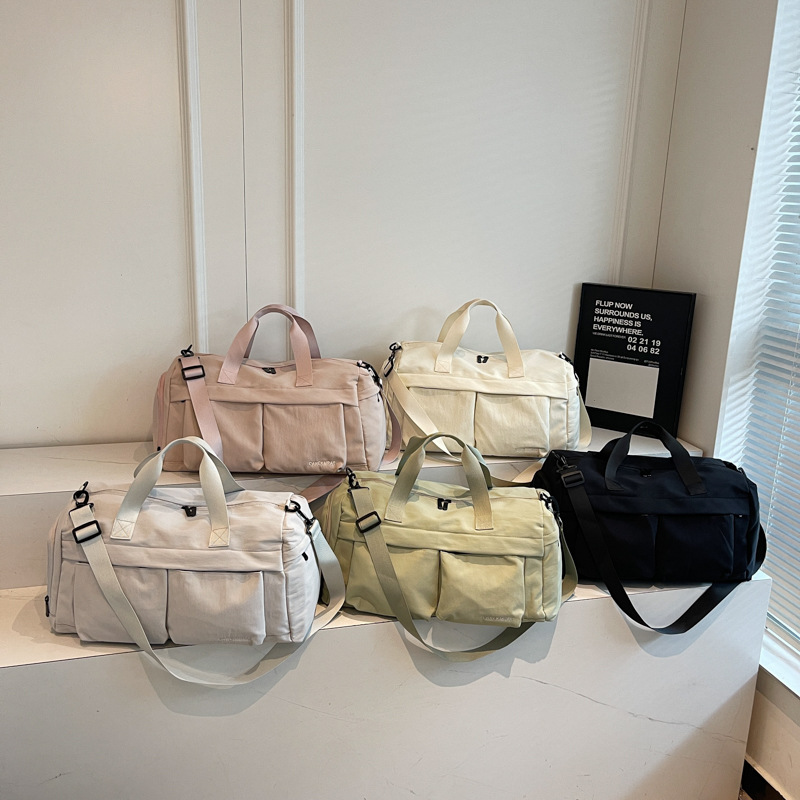 Nueva bolsa de viaje portátil simple y versátil, bolsa de equipaje de gran capacidad para mujeres, bolsa deportiva leve y casual de alta calidad.