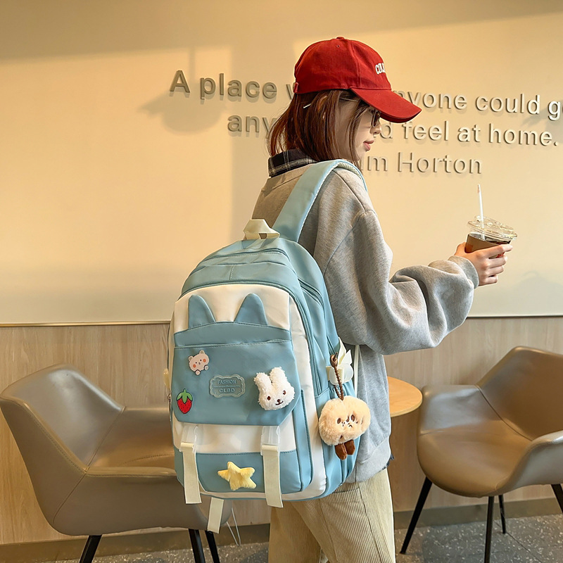 La versión coreana de las mochilas escolares de doble hombro está llena de mochilas escolares de primaria y mochilas escolares de tendencia de la escuela secundaria de gran capacidad.