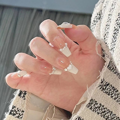 Long, nude, milky-white French-style wearable nail tips—elegant, soft, and delicate; featuring pearl accents and heart-shaped designs—ready-to-use manicure pieces.