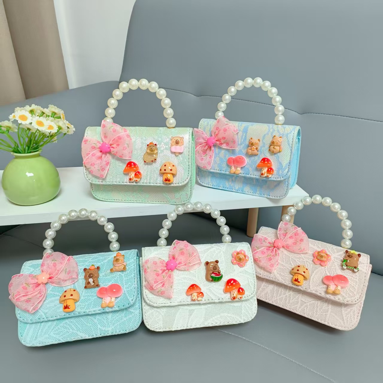 Bolsos para niños nuevos bolsos de perlas de arco para niñas bolsos de cinturón de estilo de fragancia bolsos de cadena bolsos de cambio bolsos