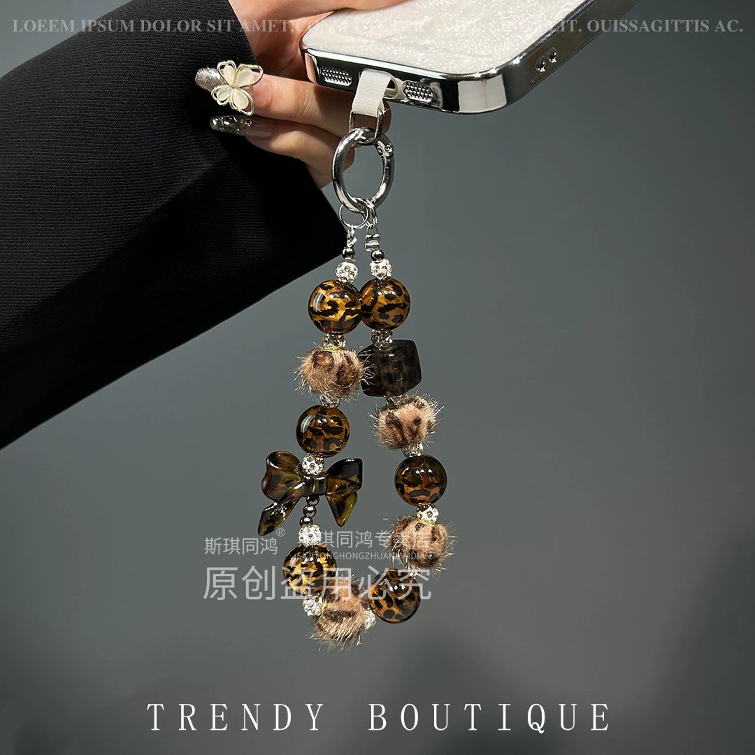 Mobile phone with bow, strap, sophisticated bracelet, pendant