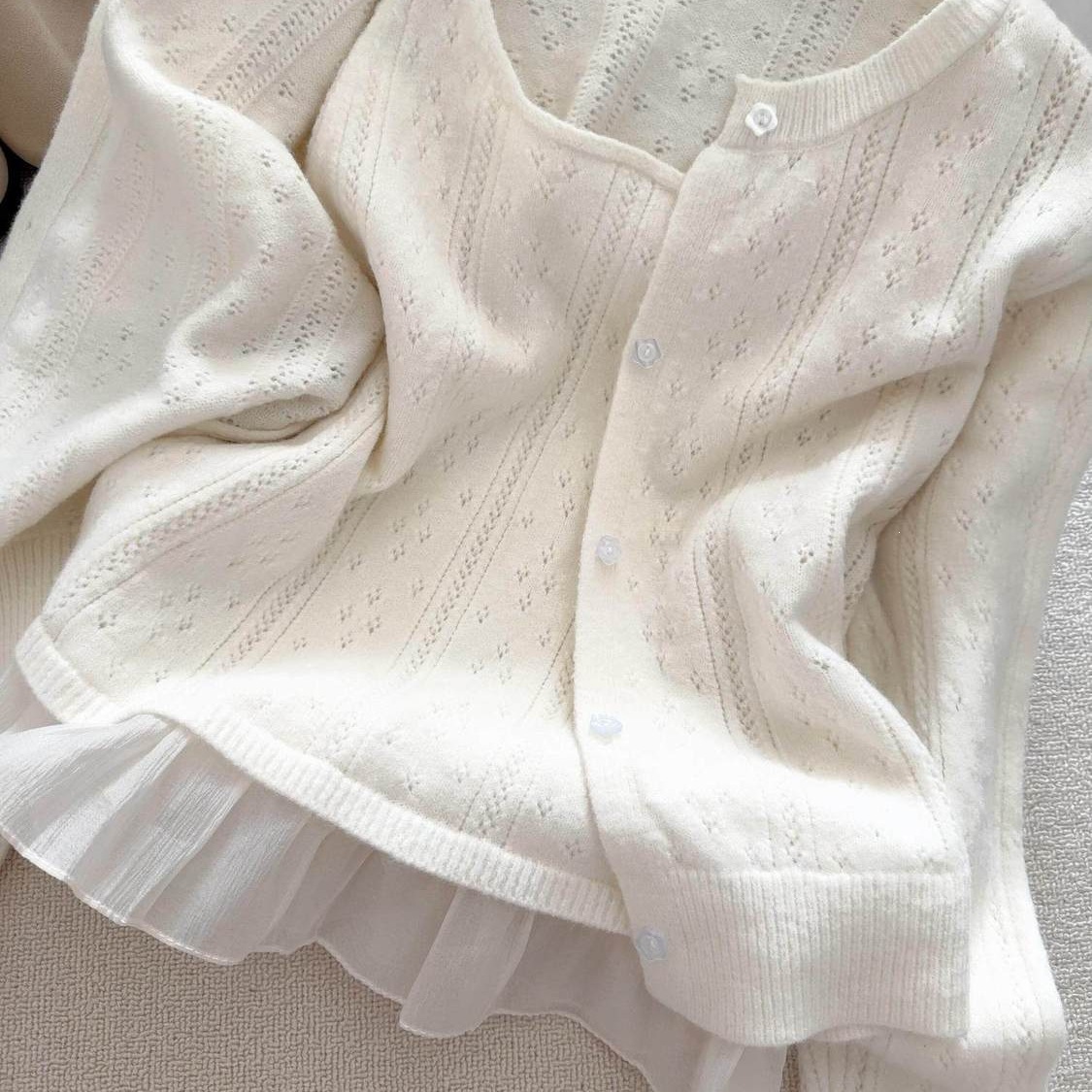 Two-piece set with a camisole and white sweater jacket for women, featuring a textured hollow-out knit cardigan, suitable for early spring, gentle style, versatile for commuting