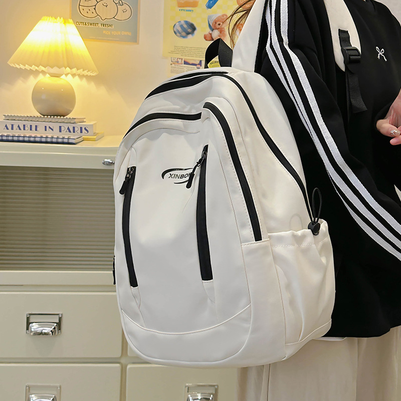 Fabricantes de mochilas escolares, estudiantes universitarias al por mayor, simples y versátiles, versión coreana de mochilas de ocio de nicho engrosadas