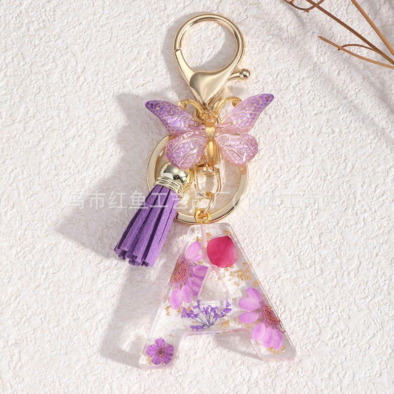 New European and American creative butterfly daisy dried flower letter key chain wholesale ladies bag accessories resin key chain