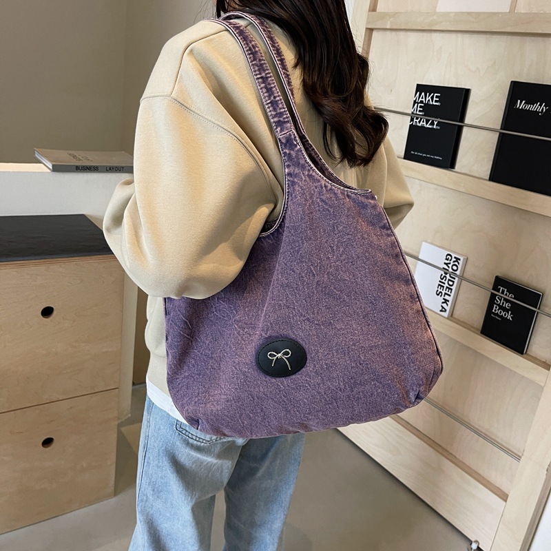 Bolso de viaje retro de mezclilla de alta gama, bolso de viaje de marca de moda de moda femenina, bolso de axila de hombro simple y casual de gran capacidad
