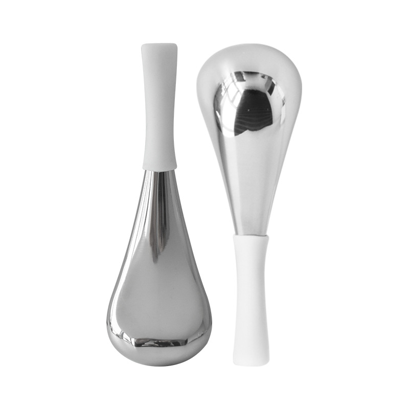 A pair of small white ice spoons