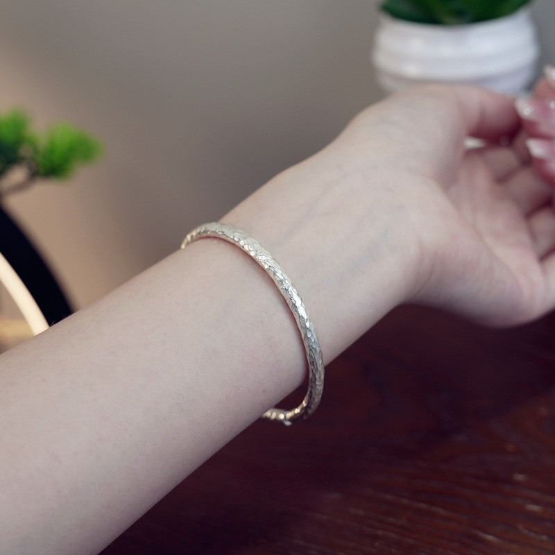 With a forged pattern silver bracelet handmade from Yunnan province