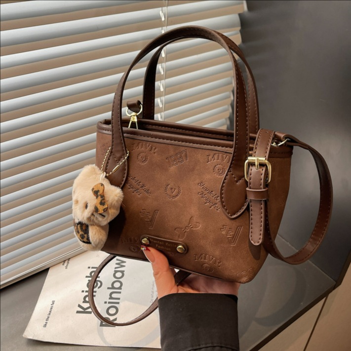 Corea del Sur super caliente retro bolso de mano de estilo extranjero para mujeres 2025 nueva moda simple hombro mochila bolso de cubo de moda