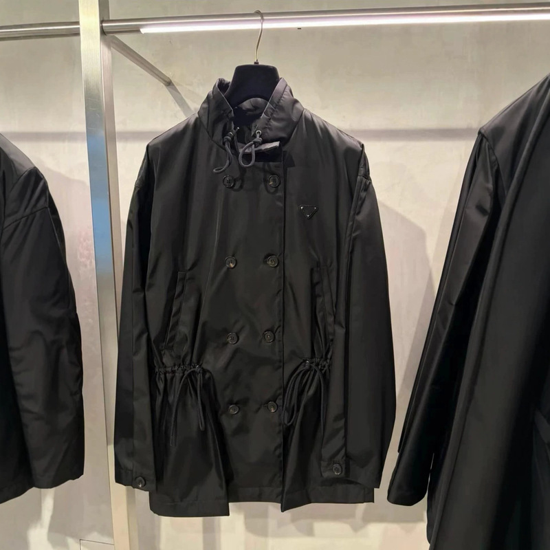 2026 new black nylon double-breasted trench coat for women, featuring a stand-up collar, drawstring waist, and a mid-length design 2026 new black nylon double-breasted trench coat for women, featuring a stand-up collar, drawstring waist, and a mid-length design