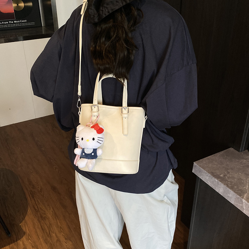 2025 nuevo bolso de cubo portátil de diseño de nicho bolso de hombro de viajero de todo fósforo de moda femenina bolso de mensajero de estilo occidental de color sólido