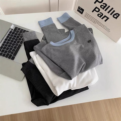 高級シンプルな色合わせの丸首の長袖のカシミヤtシャツの女性2025早春の新型のボタンは厚い底のシャツを打って保温します。