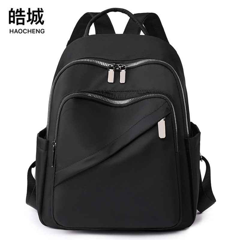 2023 verano nuevo estilo casual color sólido damas mochila de nailon moda salvaje mochila de viaje de gran capacidad al por mayor