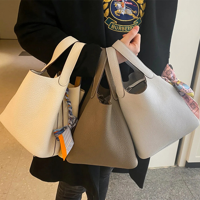 2022 nuevo color a juego bolsa de cesta de verduras bolso de cubo de piel de vaca patrón de Litchi primera capa de piel de vaca simple bolso portátil de mujer