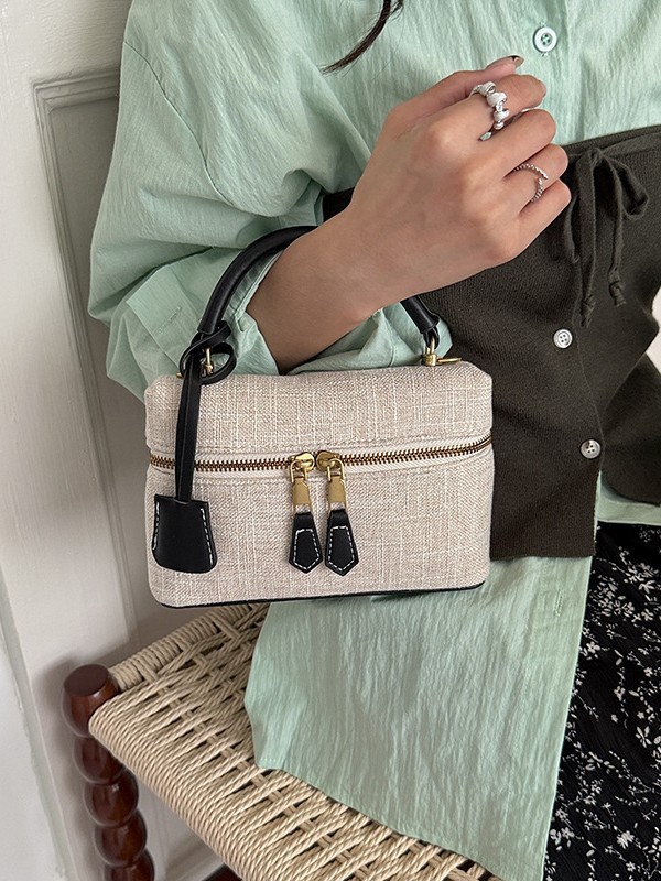 Bolso de mano de alta sensación para mujeres 2026 nuevo nicho zhong lino bolsa de almuerzo de viaje transfronterizo mochila pequeña bolsa