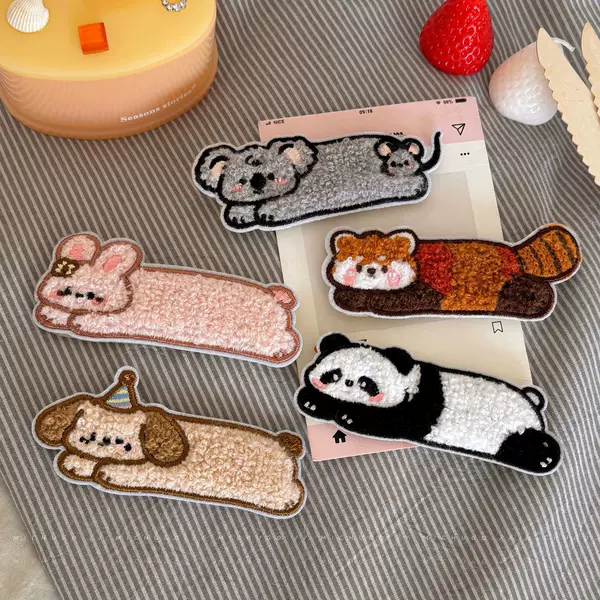 Cute plush raccoon hair clips, perfect for girls, to keep stray hairs in place and create a neat, seamless look for bangs; also available as a small bunny hair accessory