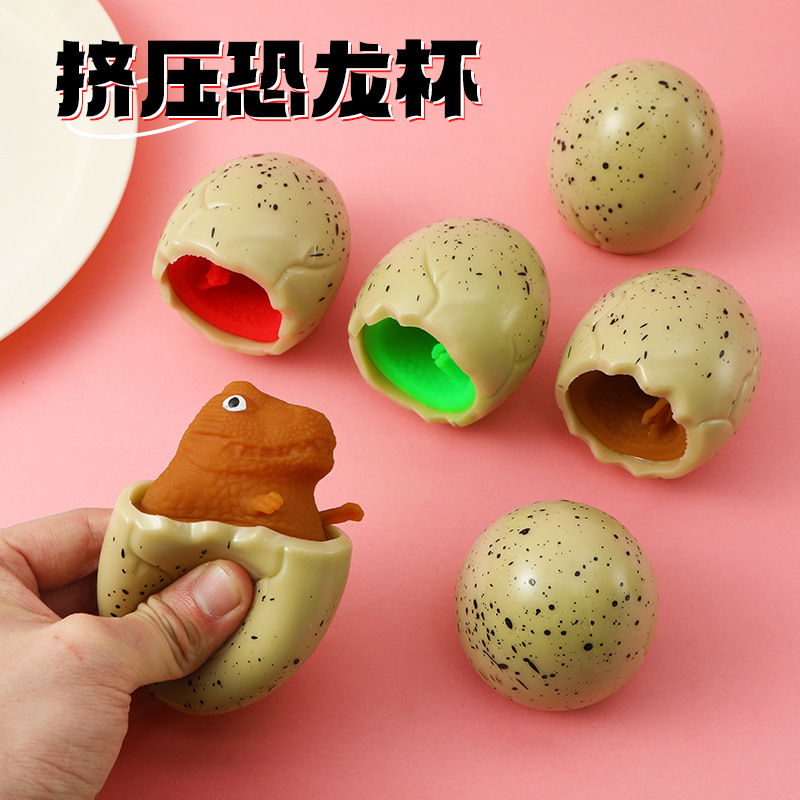 Red famosa novedad huevo de dinosaurio extruido juguete taza de dinosaurio para niños pellizco pellizco de escape bola de escape pegamento suave huevo