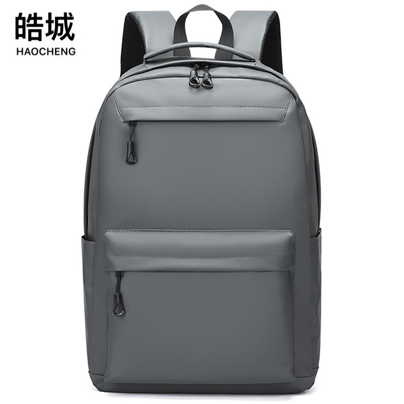 Mochila de hombre de nueva moda Mochila casual salvaje impermeable y resistente al desgaste Mochila de computadora para estudiantes de secundaria al por mayor