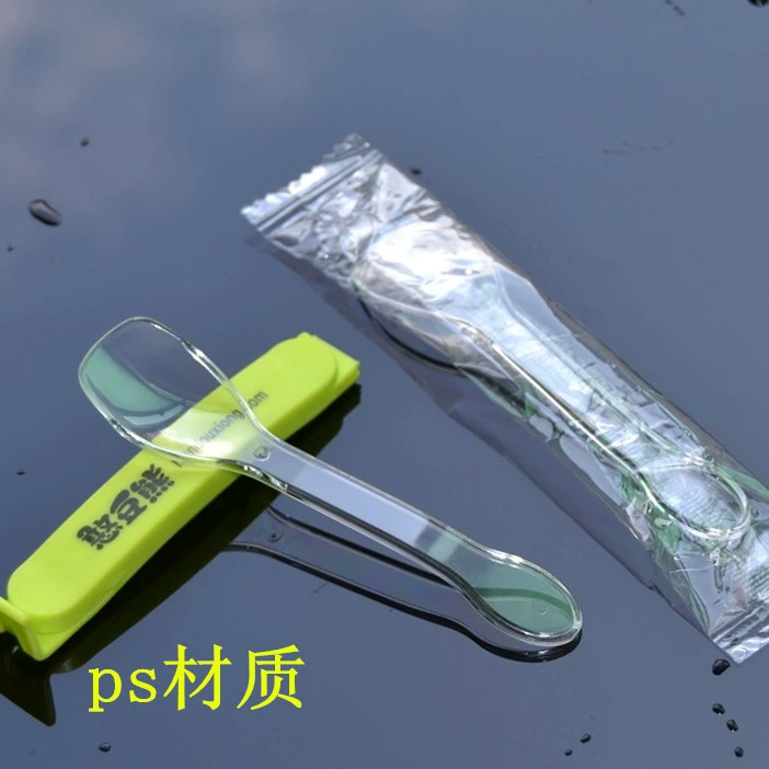 Transparent disposable plastic spoon for ice cream, mousse