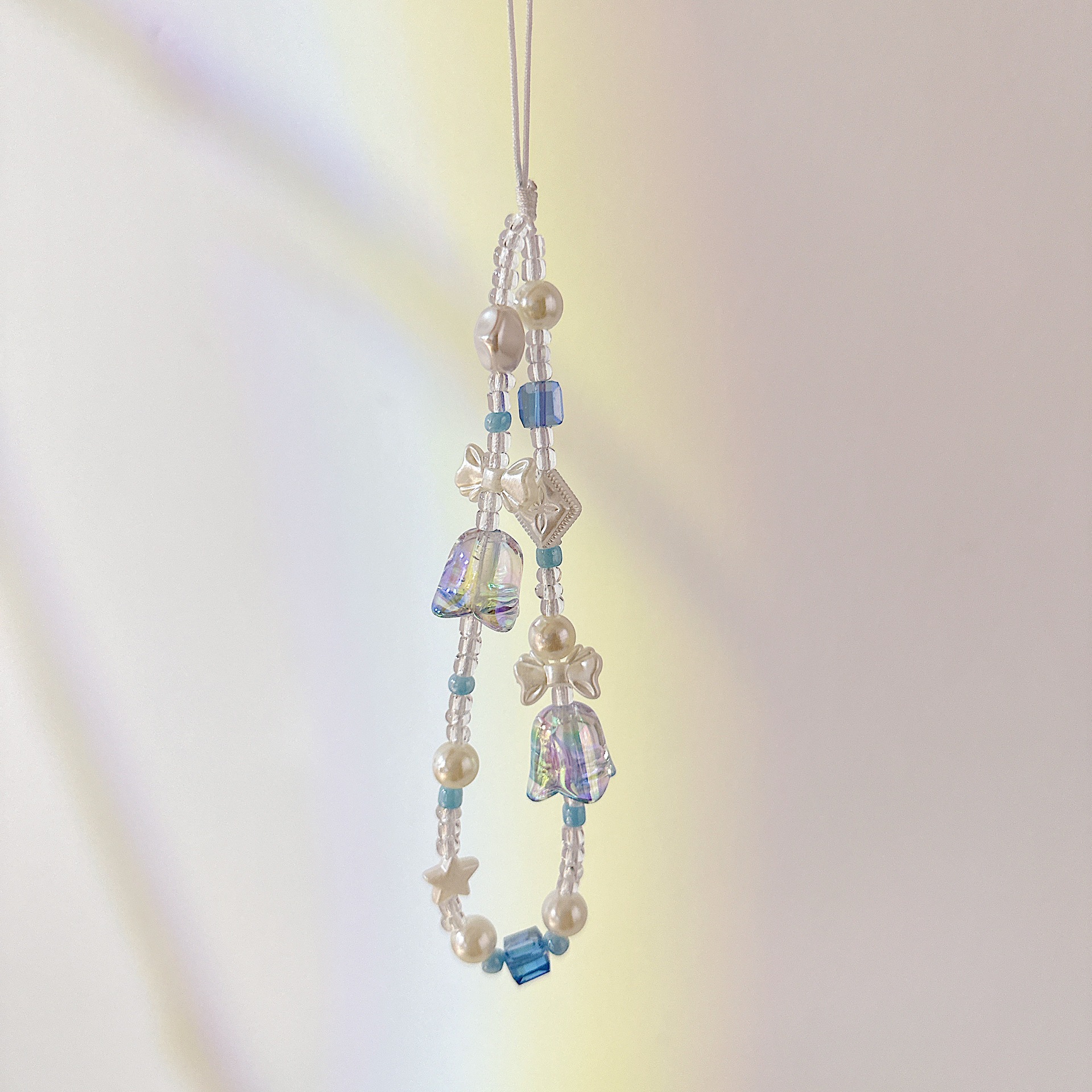 Aplicable cadena coreana orquídea de campana cadena de muñeca arco cuentas de caso de teléfono móvil colgante anti-perdida colgar pulsera trenzada