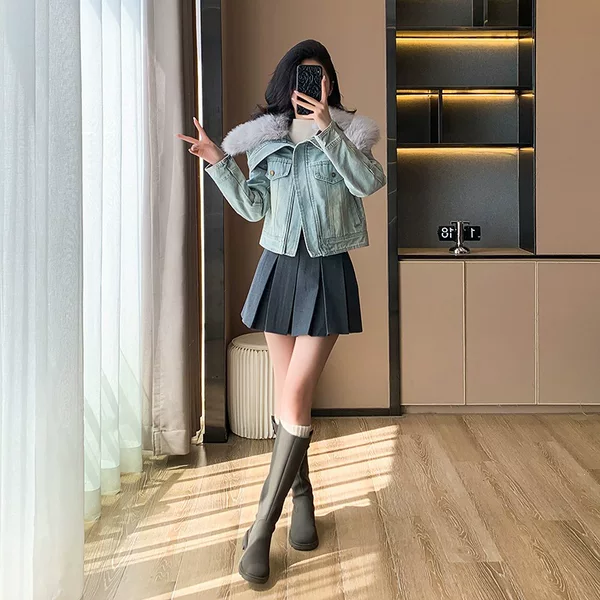 Real shot of a padded denim jacket with thick padding and large fur collar, winter casual short coat in a Chanel-inspired style, blue with gray fur