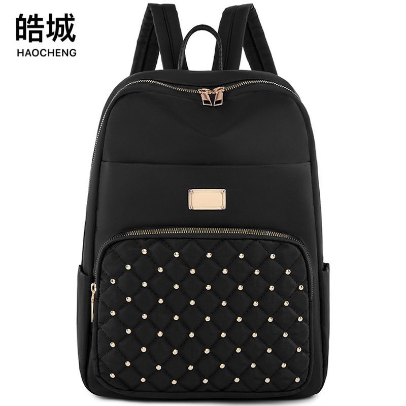 2023 nueva mochila de tela Oxford para mujer casual moda rombo remache mochila ligera mochila de viaje urbano