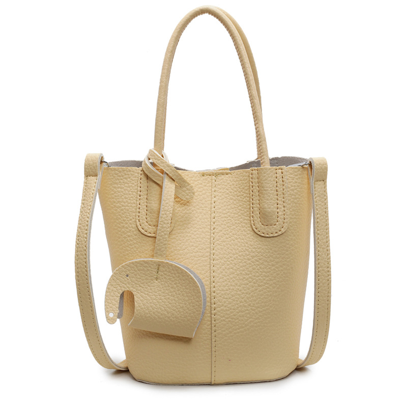 Bolso de cubo de venta caliente de comercio exterior, sentido de alta gama de nicho femenino 2025 nuevo bolso de mano simple y versátil, bolso de mensajero de moda y versátil