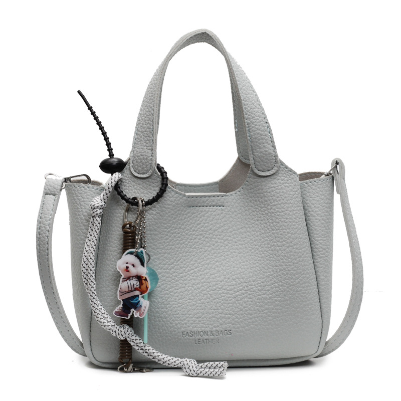 Bolso de cubo de mano transfronterizo sentido de alta gama para mujer 2025 nuevo bolso de mensajero de un solo hombro simple y versátil bolso de canasta de verduras de nicho