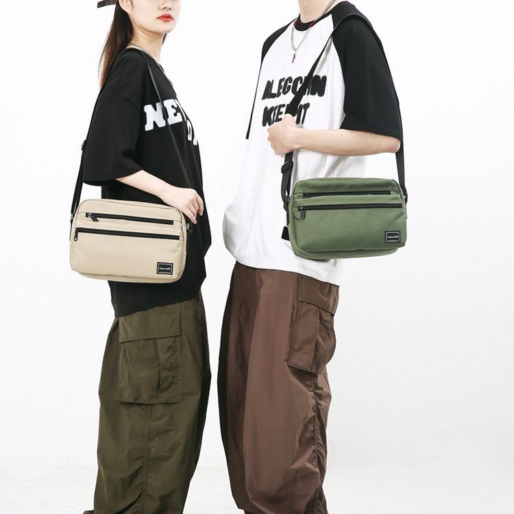 Bolso de hombro de los hombres japoneses ins estilo bolso de mensajero casual personalizado de moda estilo coreano bolso de mensajero estudiante pequeño bolso de hombro femenino