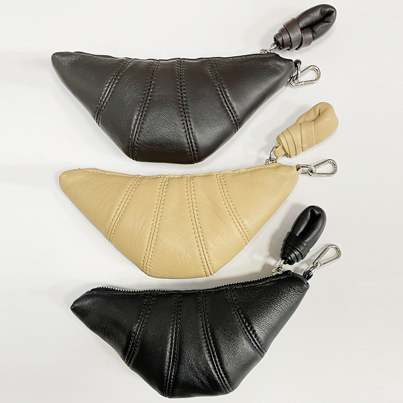 Mini genuine leather coin purse/croissant bag with a unique design; a stylish crossbody bag for carrying lipsticks and headphones.