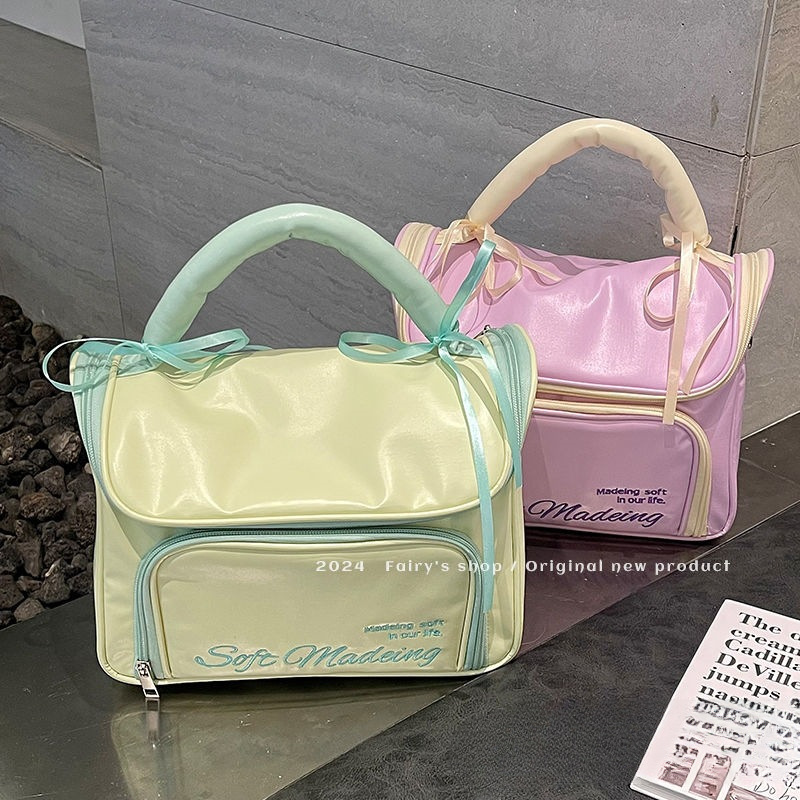 Handheld capacious cosmetic bag with bow to go out