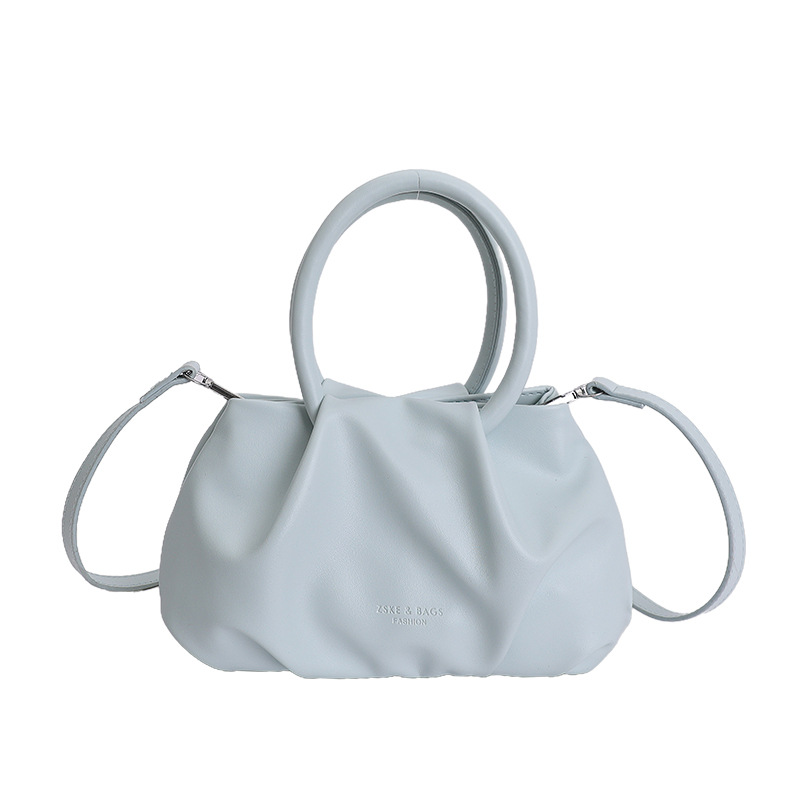 Alta sensación de mano pliegueada nube bolso de cubo para mujeres 2026 nuevo nicho de lujo ligero de moda perla bolsa de mochila