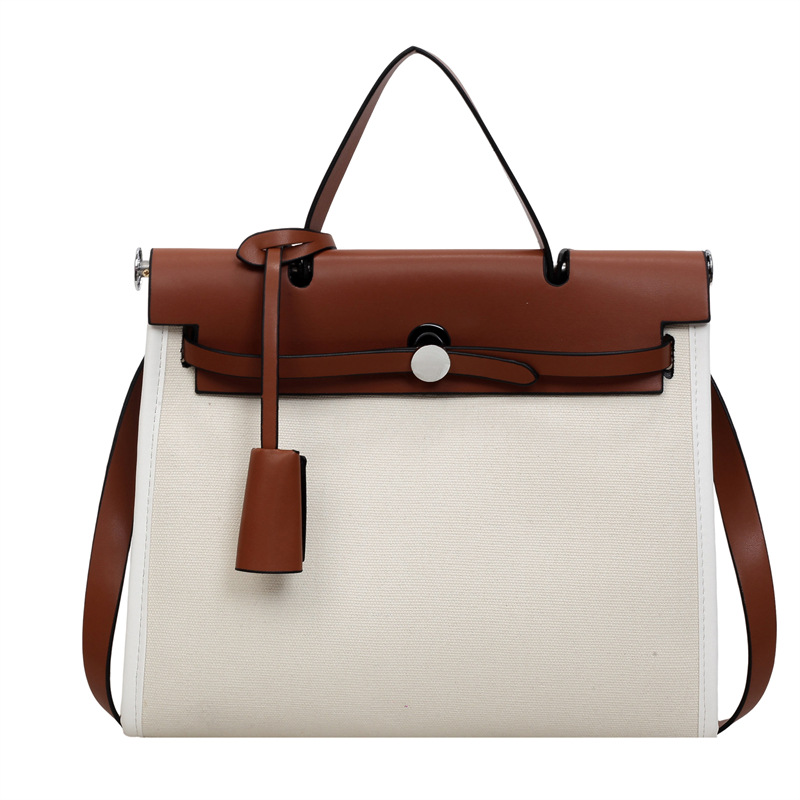 Nicho de moda portátil Kelly bolso mujer 2026 nuevo cross-border lienzo empalme color contraste viaje mochila de hombro