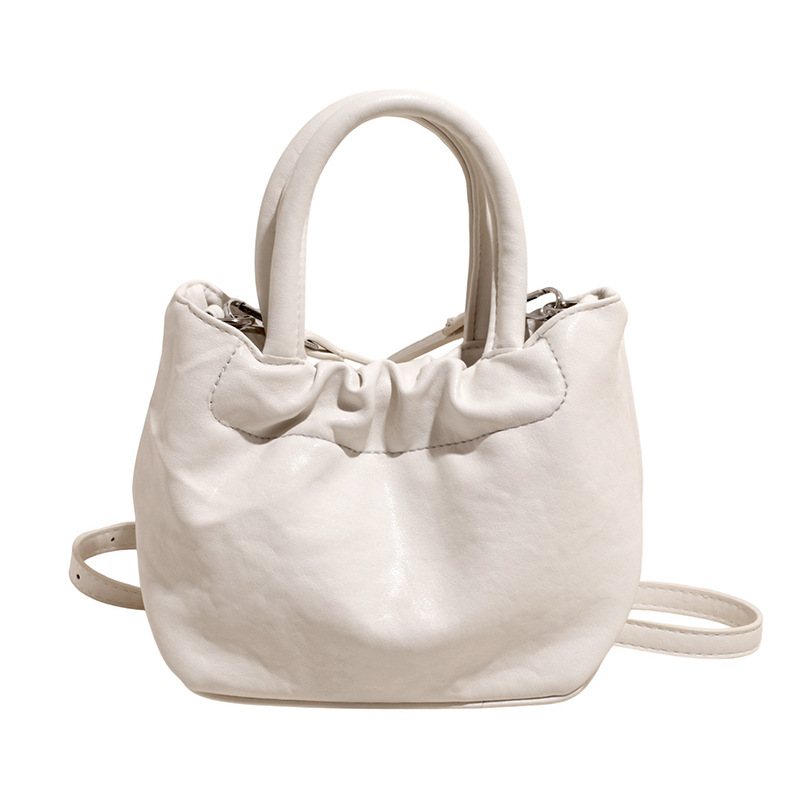 2025 nuevo bolso de cubo portátil de color sólido de diseño de nicho para mujer, bolso de mensajero de un solo hombro simple y moderno de alta gama para mujer