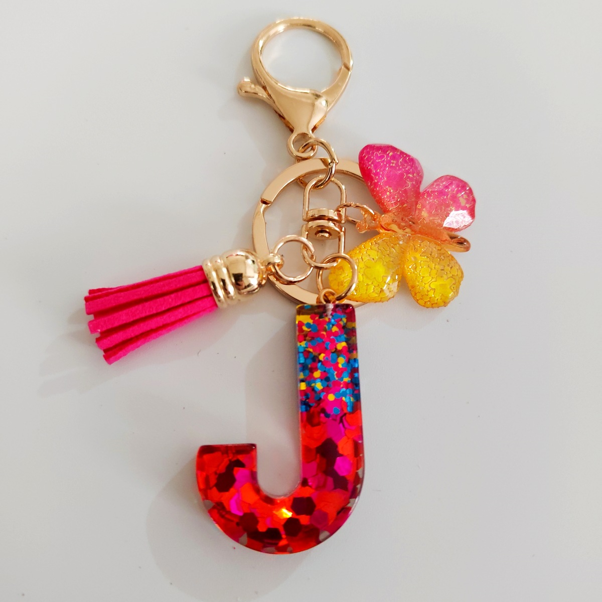Ventas transfronterizas calientes de letras inglesas de color mixto colgante de llavero colgante de mariposa fringe de resina de llavero colgante de joyería