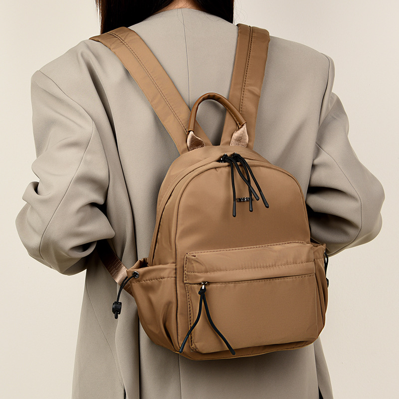 2025 nueva mochila de viaje simple de color sólido mochila de mujer casual letras extranjeras mochila de gran capacidad