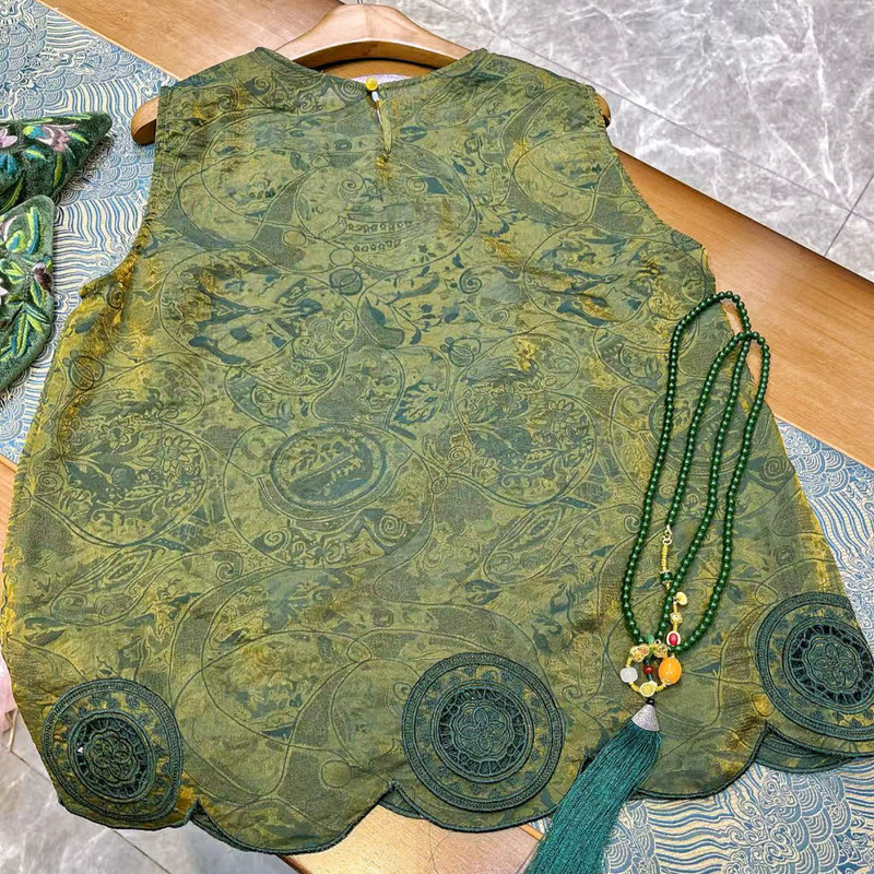 The Heavy Embroidered Floating Brocade Vest Has a Unique Sleeveless Design with Hollow Round Patterns and Scallop-Shaped Edges at the Hem