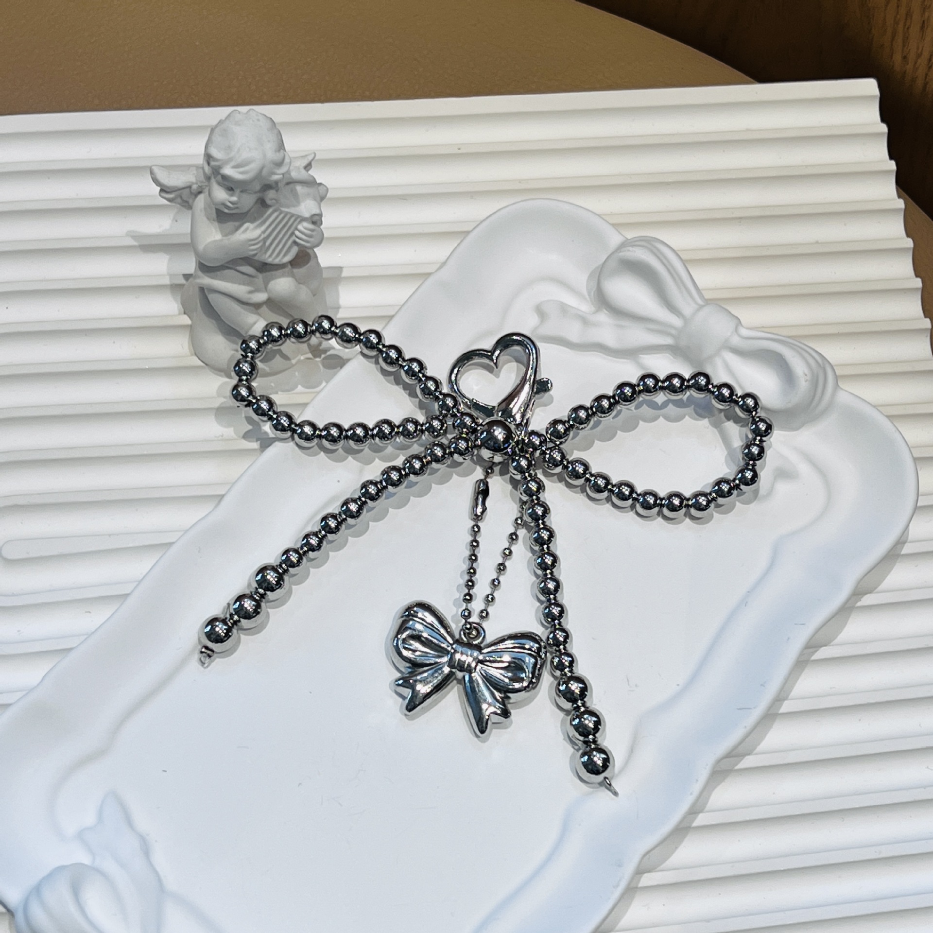 Amor botón arco bola de acero colgar arco