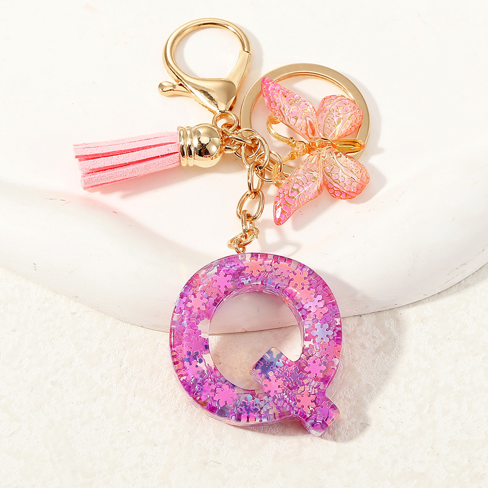 Nuevo color púrpura claro mezcla de polvo brillante letras inglesas resina llave colgante estilo simple mariposa borda colgante