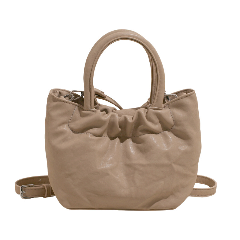 2025 nuevo bolso de cubo portátil de color sólido de diseño de nicho para mujer, bolso de mensajero de un solo hombro simple y moderno de alta gama para mujer