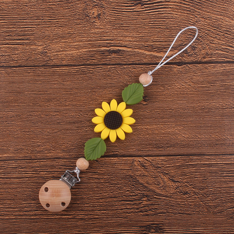 Nuevos suministros para bebés clip de chupete de haya calmante bebé girasol mordedura de silicona chupete cadena anti-caída de la cadena