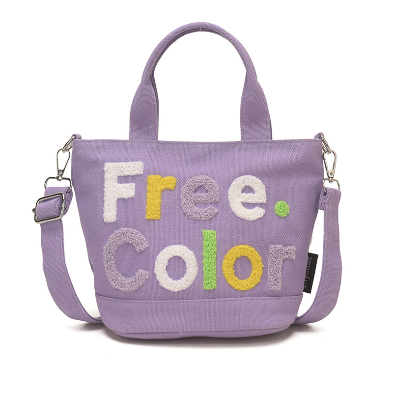 Mamá bolso para salir bolso de cubo de mano mujer 2026 nuevo bolso de lona bordado de dibujos animados letras casuales bolso de mochila