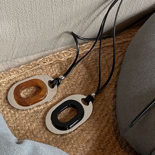 European and American Cold Style Niche Design Sense Titanium Steel Color-free Oval Pendant Long All-match Leather Rope Necklace Woolen Chain