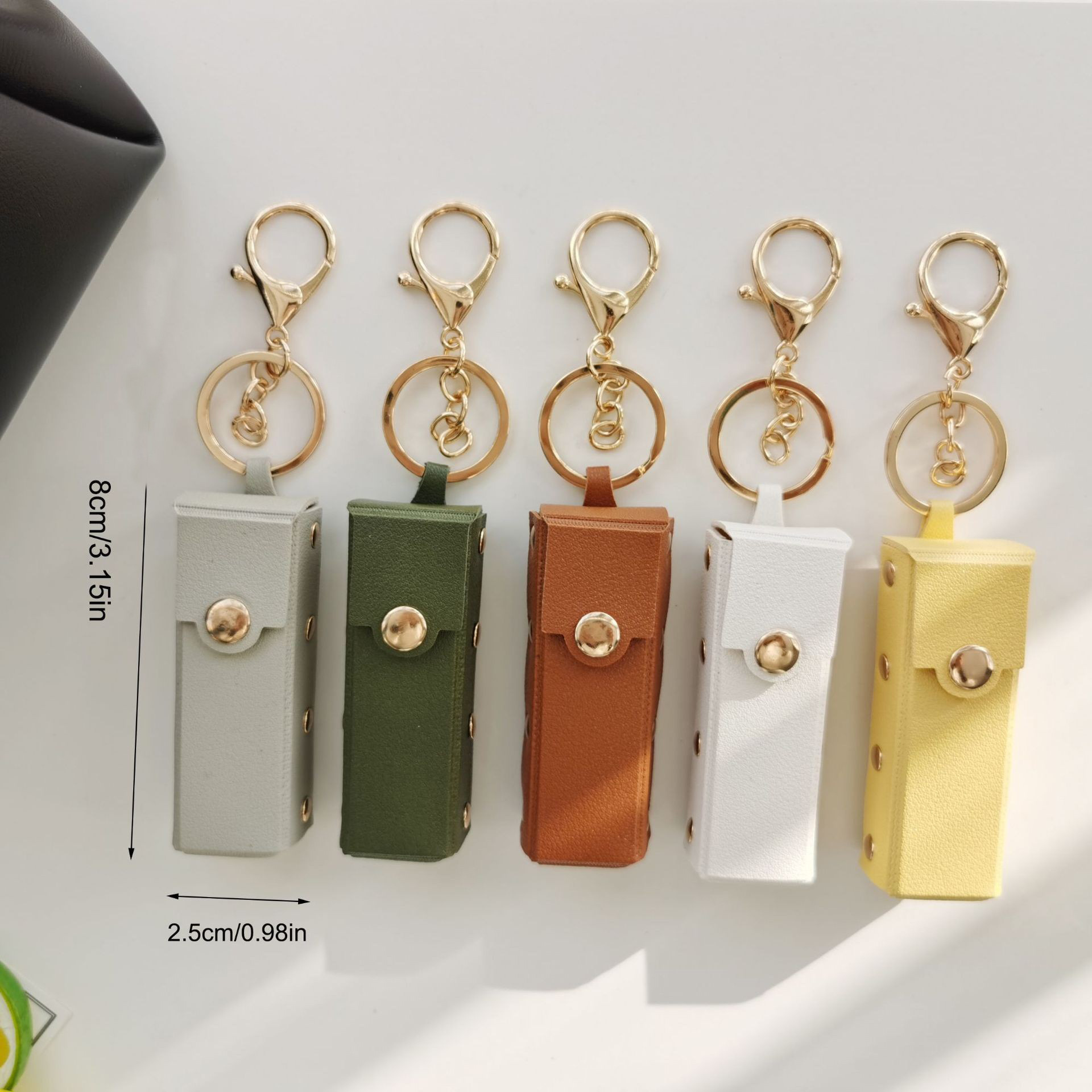 Fábrica directa remache lápiz labial bolsa llavero pequeño regalo PU cuero portátil transfronterizo coche bolsa colgante